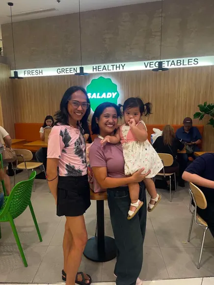 A teammate with her daughter at the office