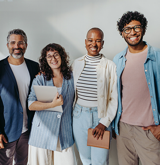 Group of people standing close together smiling in casual attire, holding notebooks and a tablet, representing the four different faith-based donor profiles