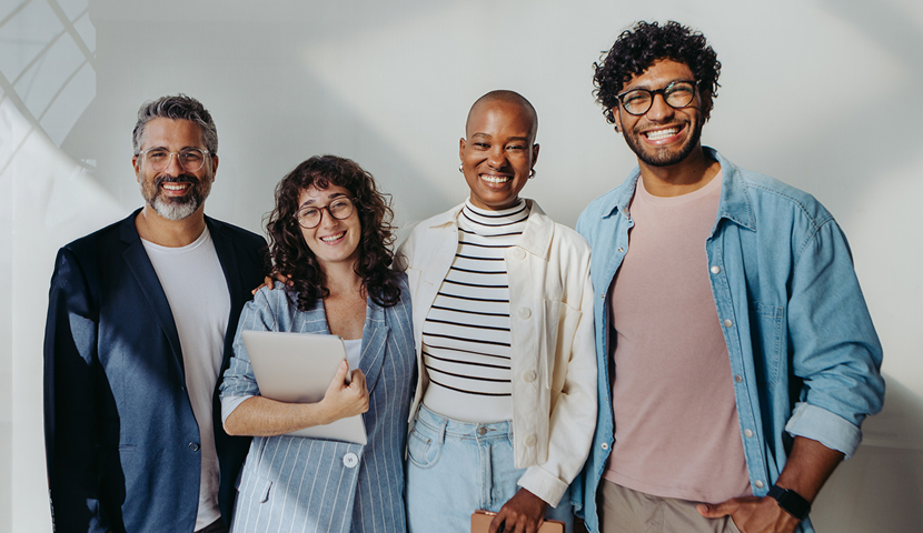 Group of people standing close together smiling in casual attire, holding notebooks and a tablet, representing the four different faith-based donor profiles
