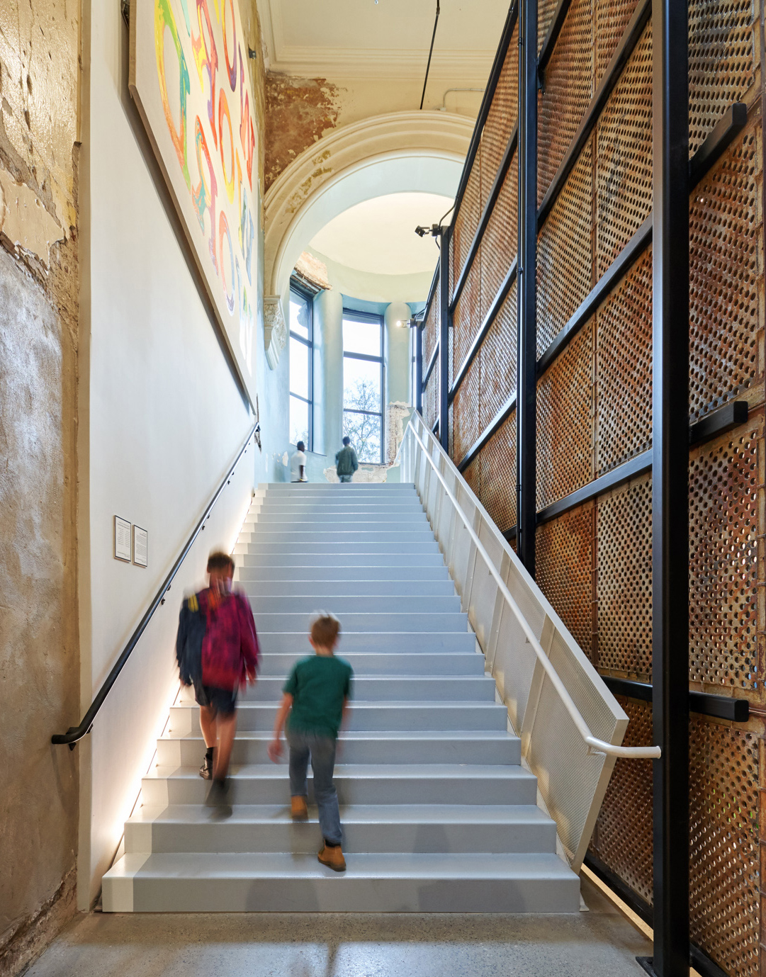 A large staircase with two people walking.