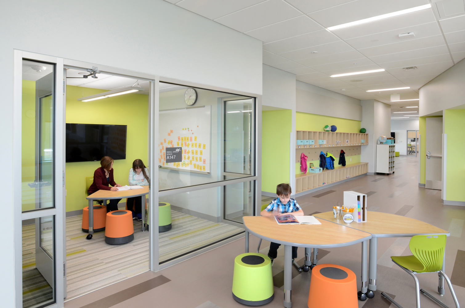 A hallway of an office building with multiple offices.