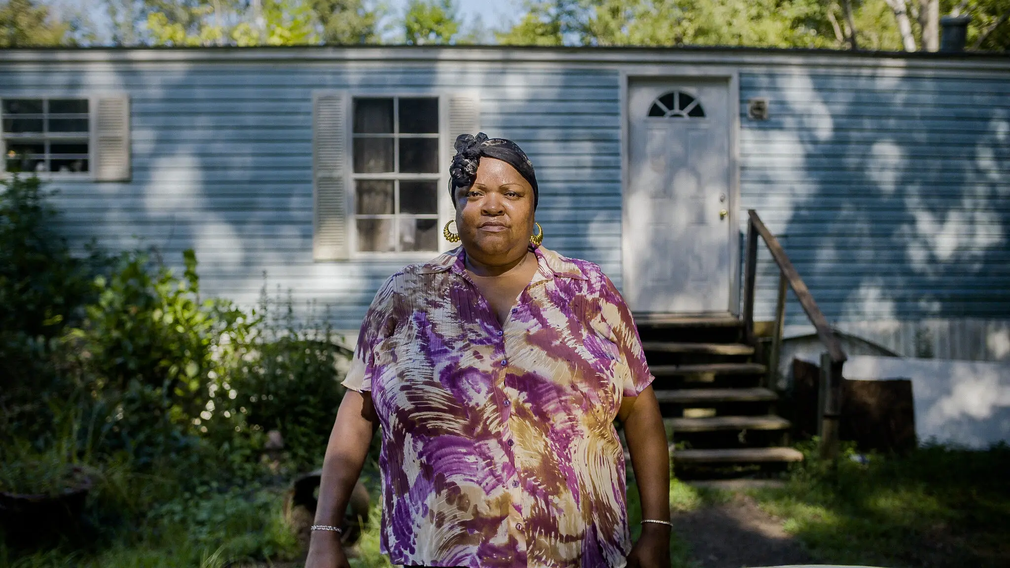 Pamela Rush, an environmental justice advocate standing in front of her home in Tyler, Alabama. 