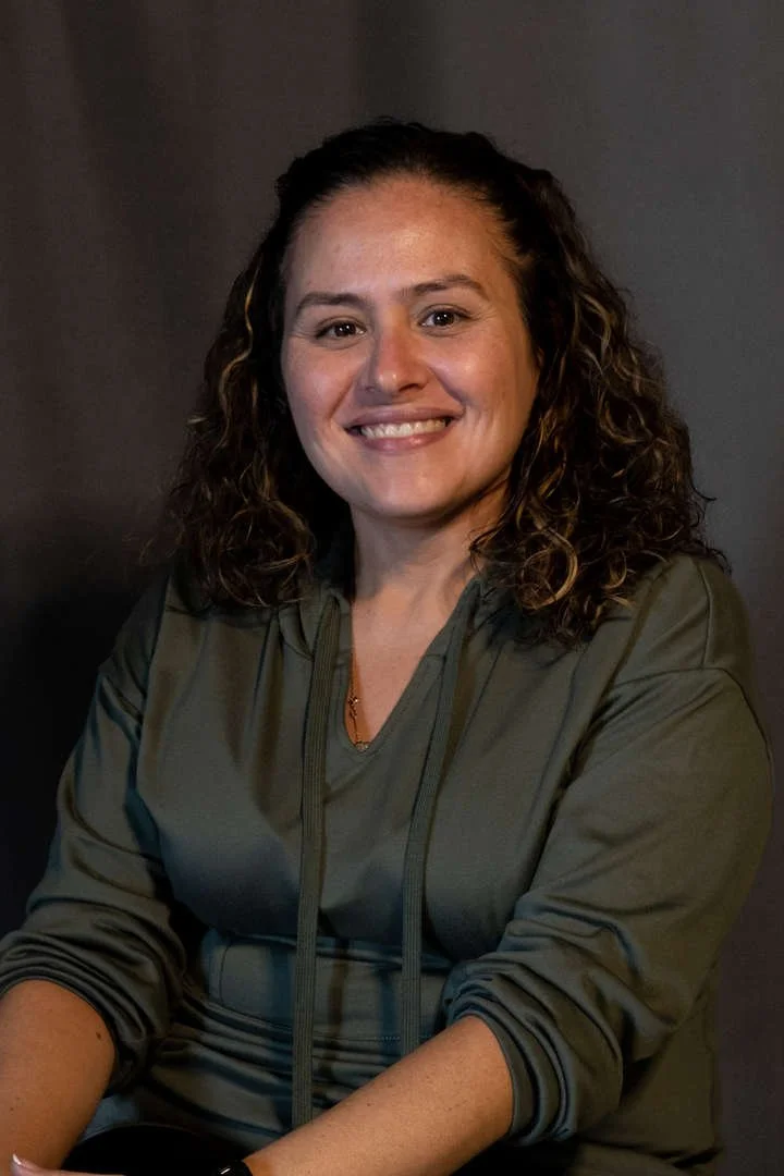 Staff member S Vasquez smiling in professional portrait photo