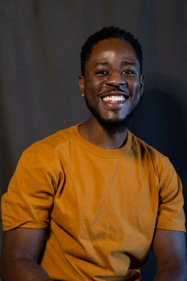 J. Lewis smiling in a staff directory portrait photo