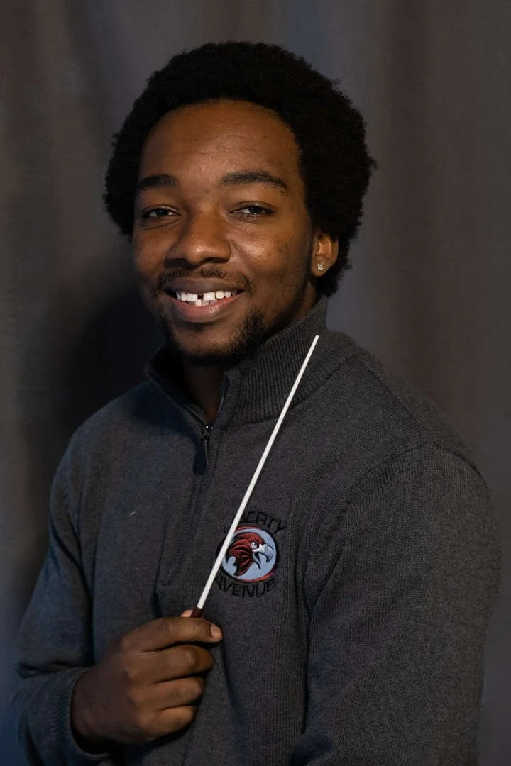 Liberty Avenue student or staff member holding a conductor's baton