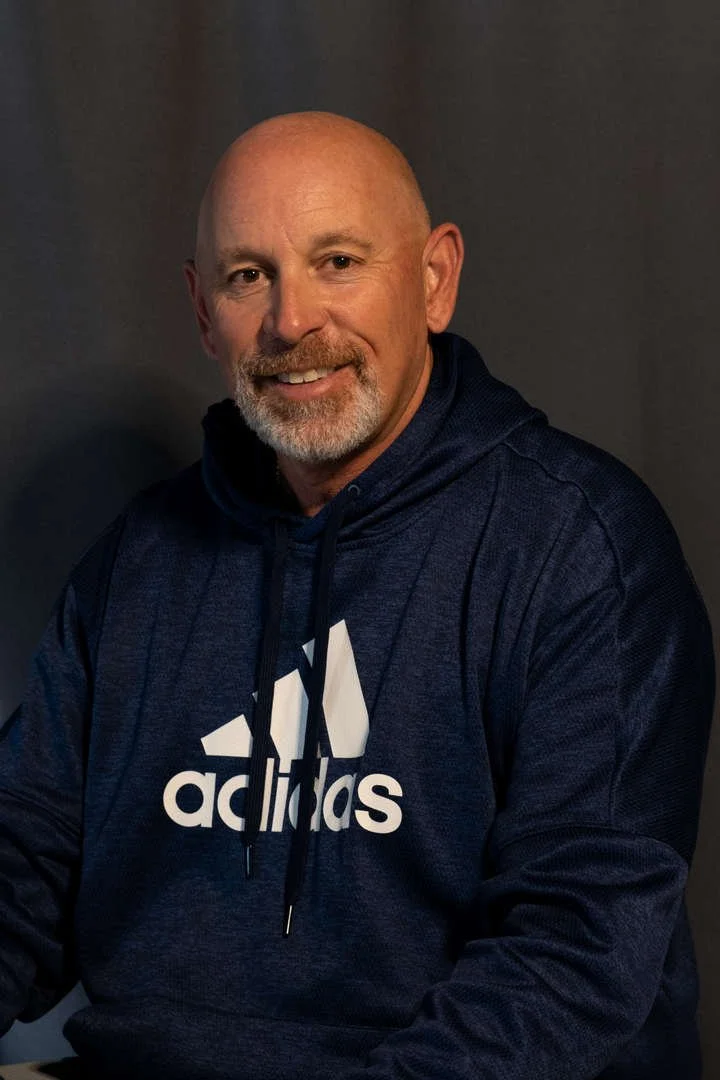 Staff portrait of J. Gilbert wearing a navy Adidas hoodie