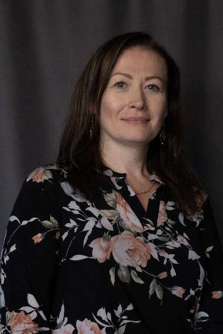 Staff portrait of A. Holstein in a floral blouse