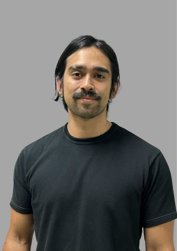 B. Araque staff headshot smiling in black shirt