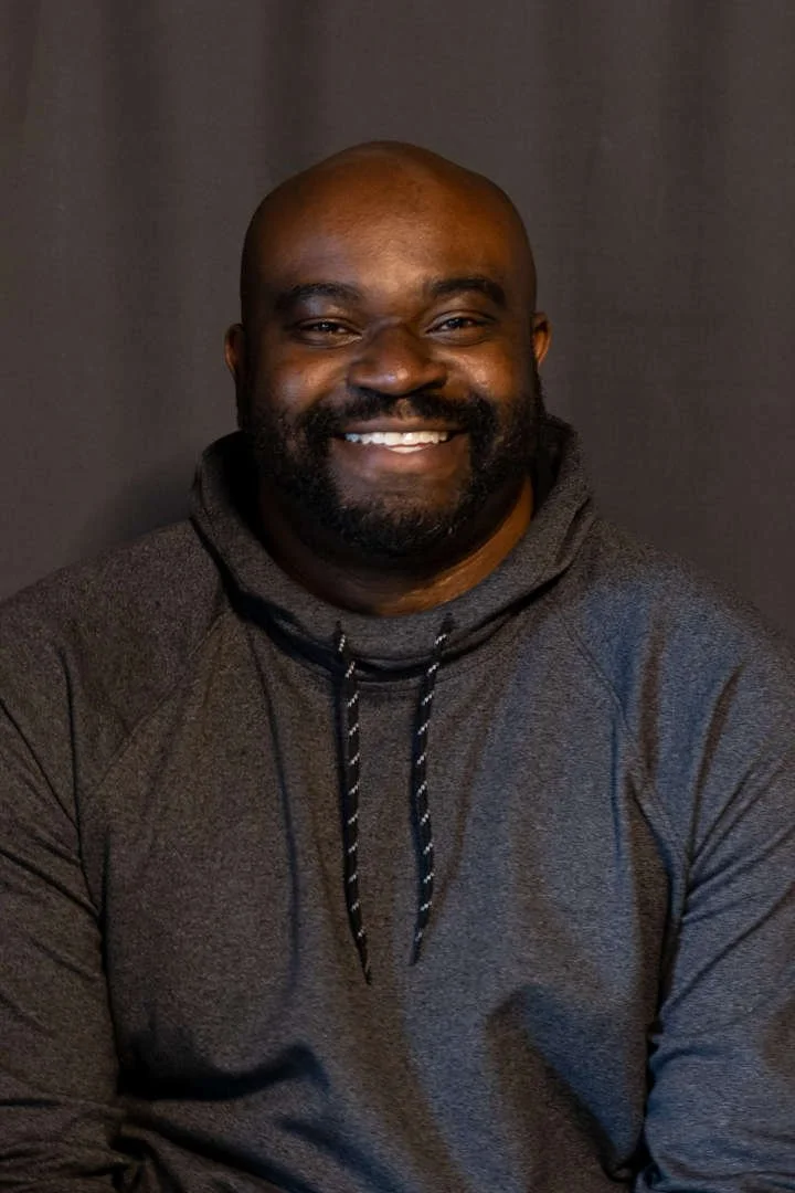 Staff member M. McGill smiling in professional headshot photo