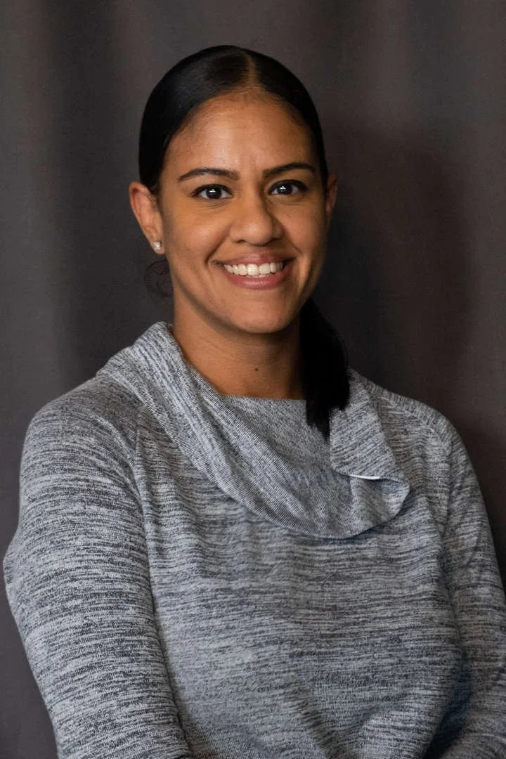 Staff member J Fernandez smiling in professional headshot photo