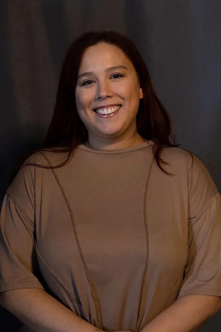 J Merced smiling in a professional staff portrait photo