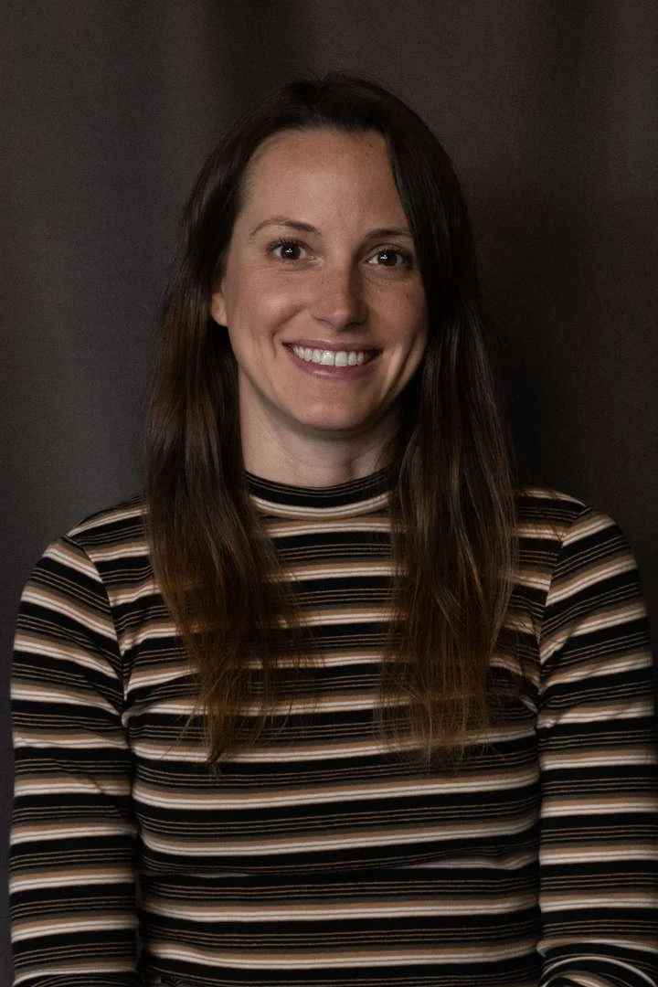 Staff member S. Lucas smiling in professional headshot photo