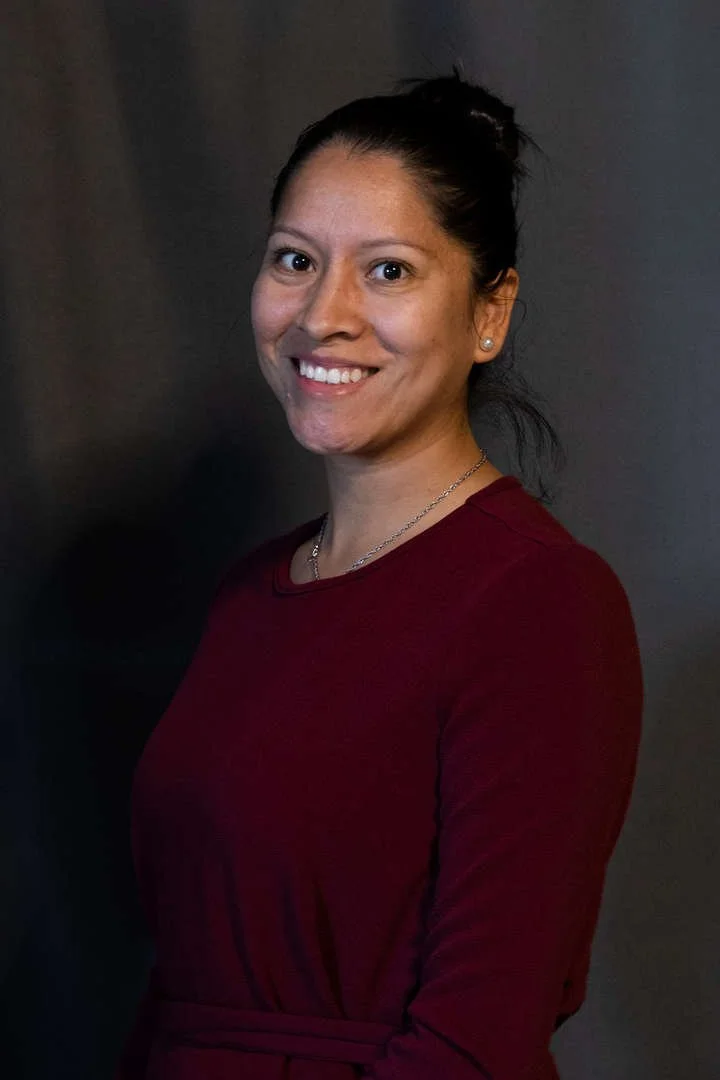 Staff member R. Ortiz smiling in professional portrait photo