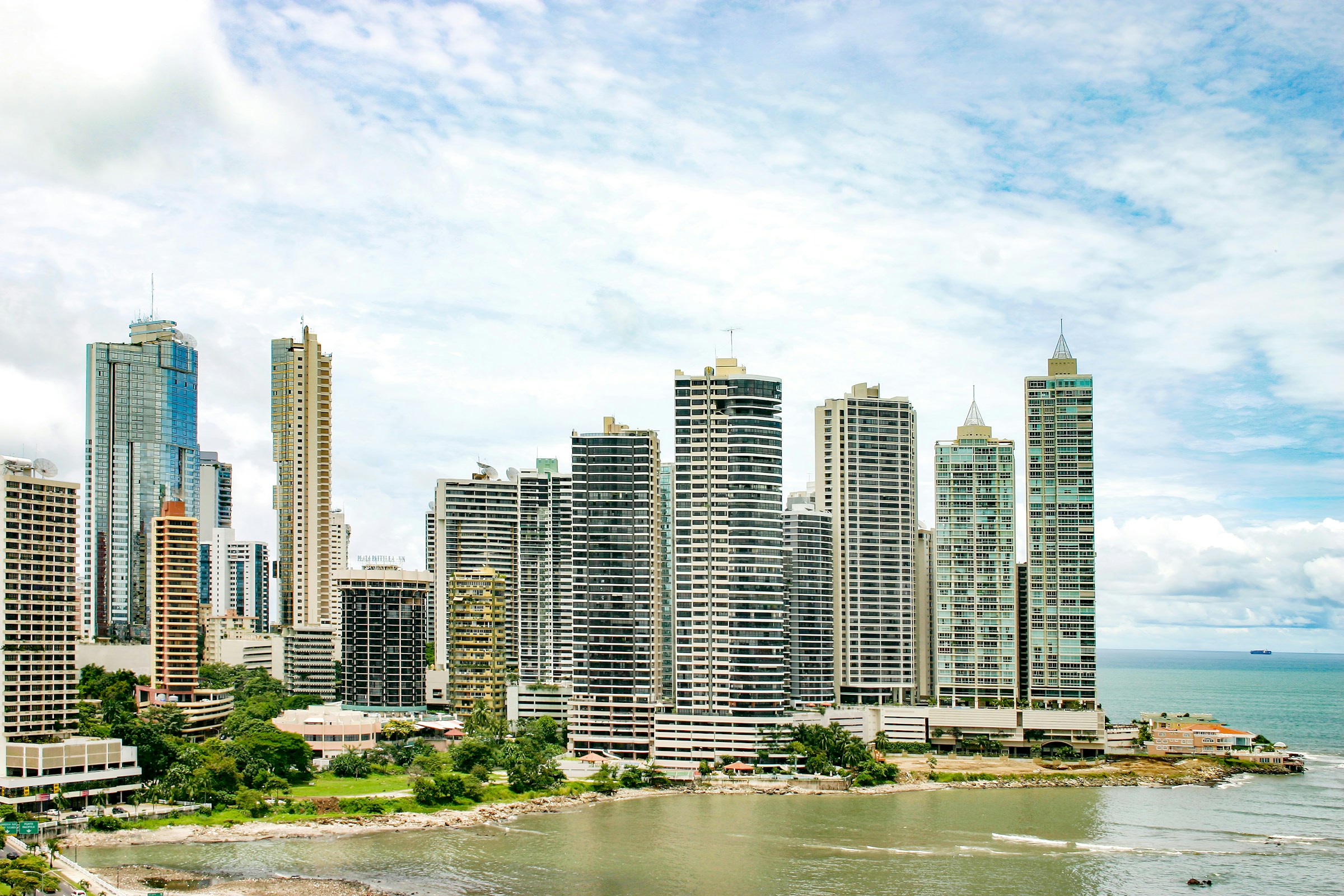 Panama City skyline across the bay under a blue sky, Panama