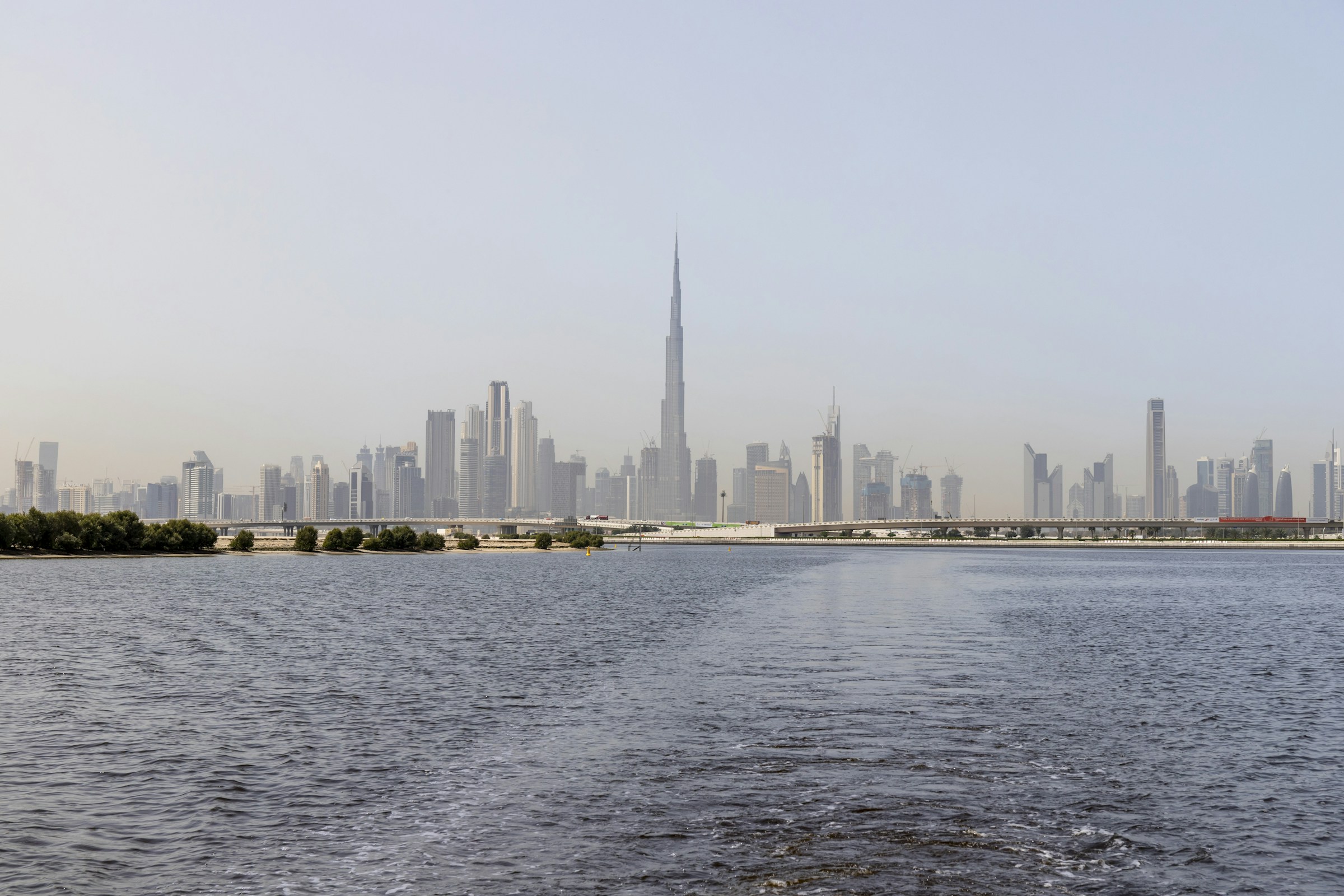 Downtown Dubai skyline across the water in daylight, United Arab Emirates