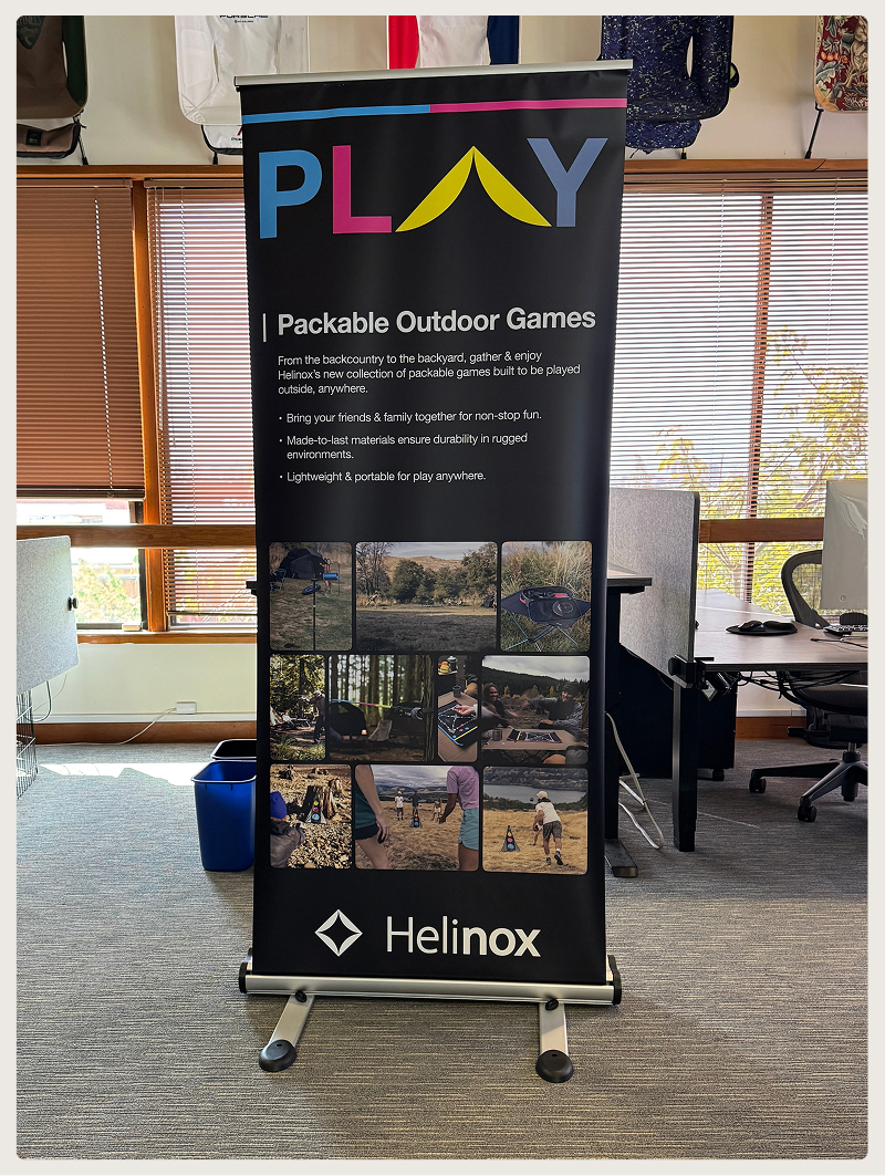 Black banner for Helinox packable outdoor games with colorful PLAY text and outdoor game images.