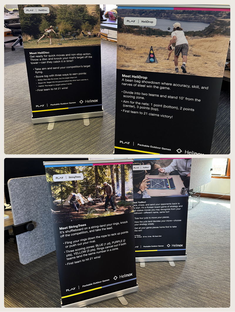Four Helinox banner stands display outdoor games: HeliDisc, HeliDrop, StringTrees, and YutNori with gameplay details.
