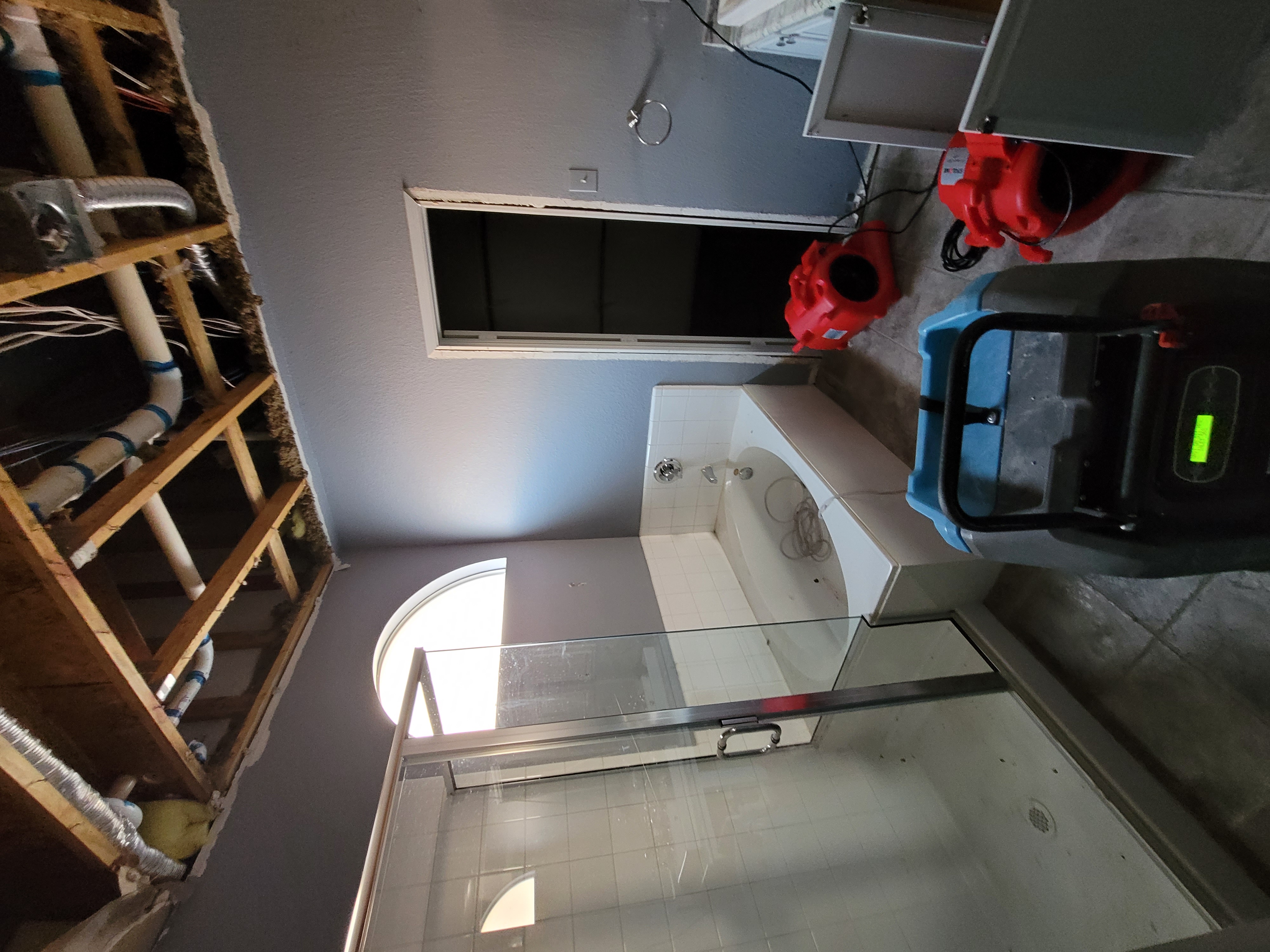 Close-up of brown cushioned over-ear headphones resting on a wooden surface in moody lighting.