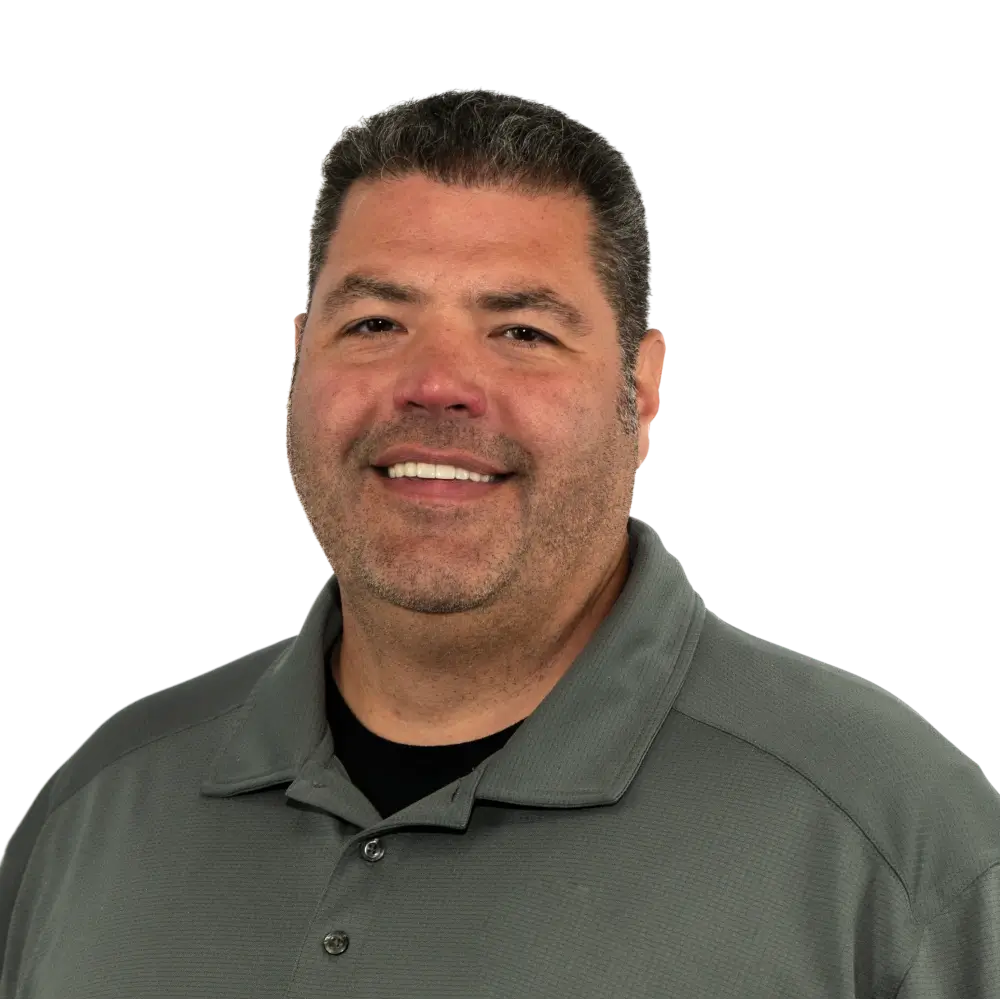 Smiling man with short dark hair wearing a gray collared shirt.