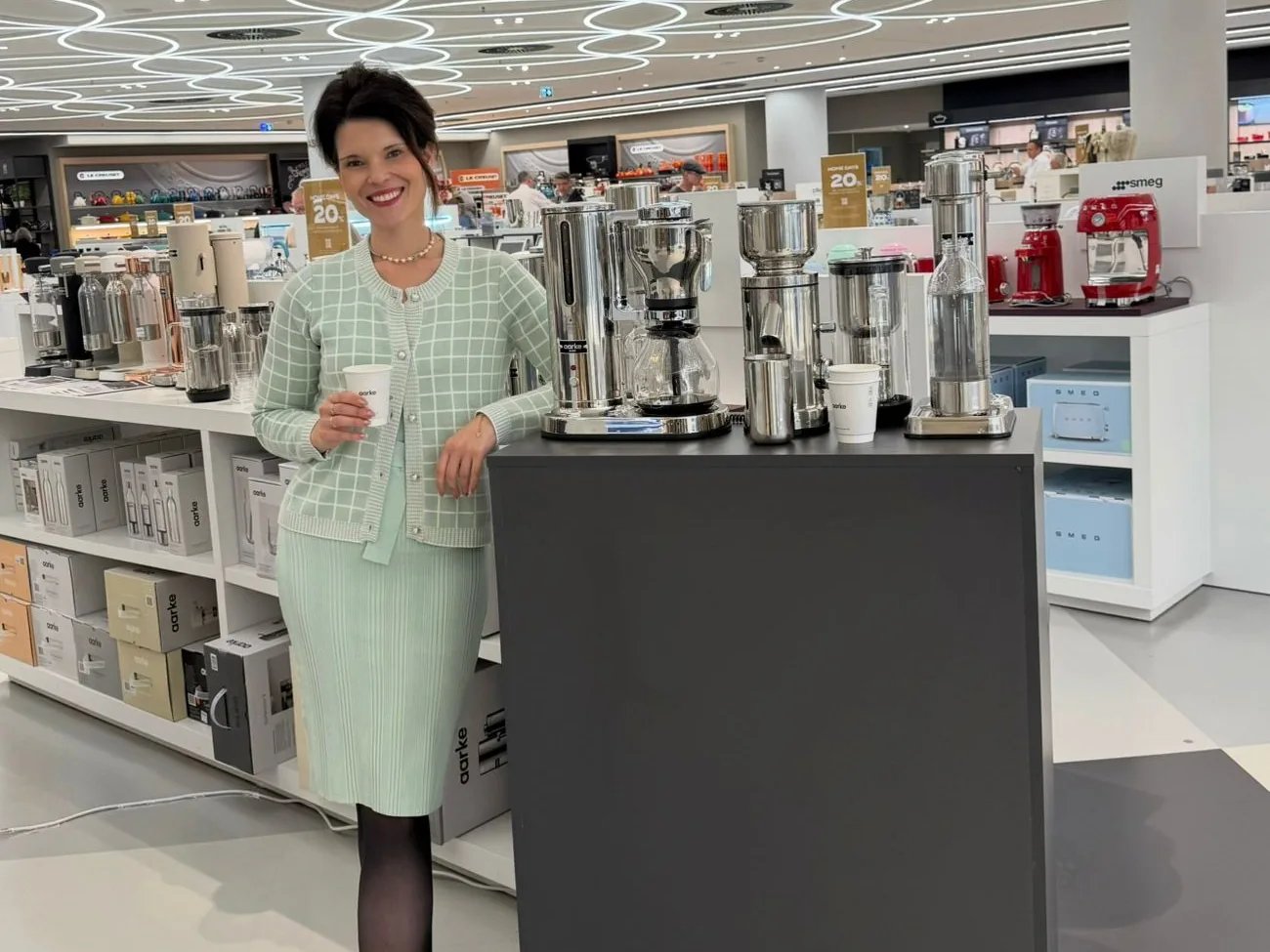 Produktberaterin am Aarke-Stand mit Wassersprudler und Kaffeebereitern im KaDeWe Berlin