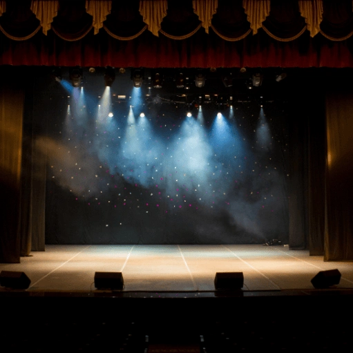 Theater stage illuminated for live performances, presentations, and special events.