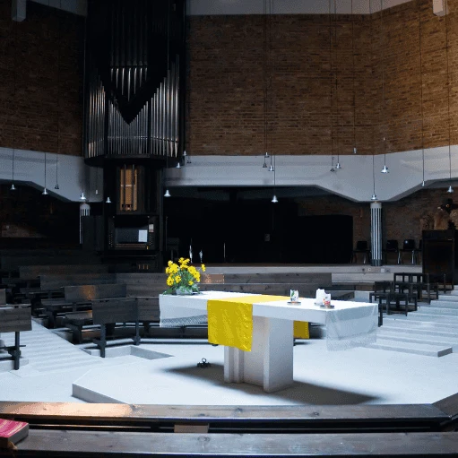 Modern worship space viewed from the altar, designed for congregation gatherings and services.
