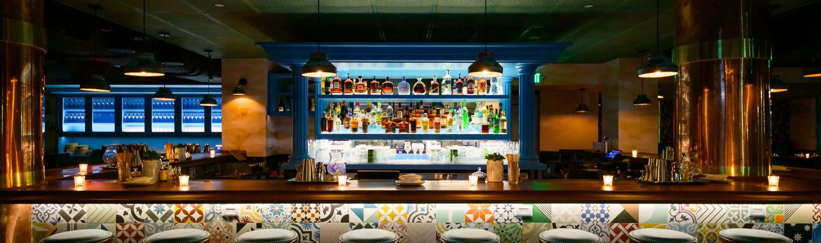 Restaurant bar with dynamic architectural lighting creating an energetic nightlife atmosphere.