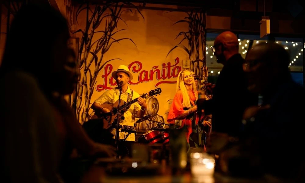 Live band performing on stage in a vibrant restaurant entertainment venue.