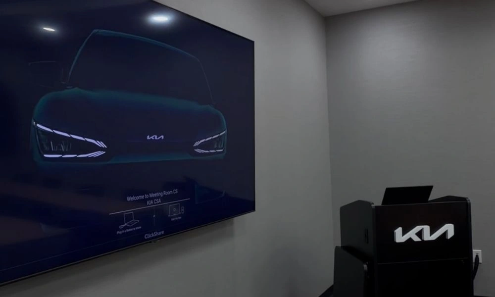 Presentation area with large display, presenter lectern, and integrated conference room technology.
