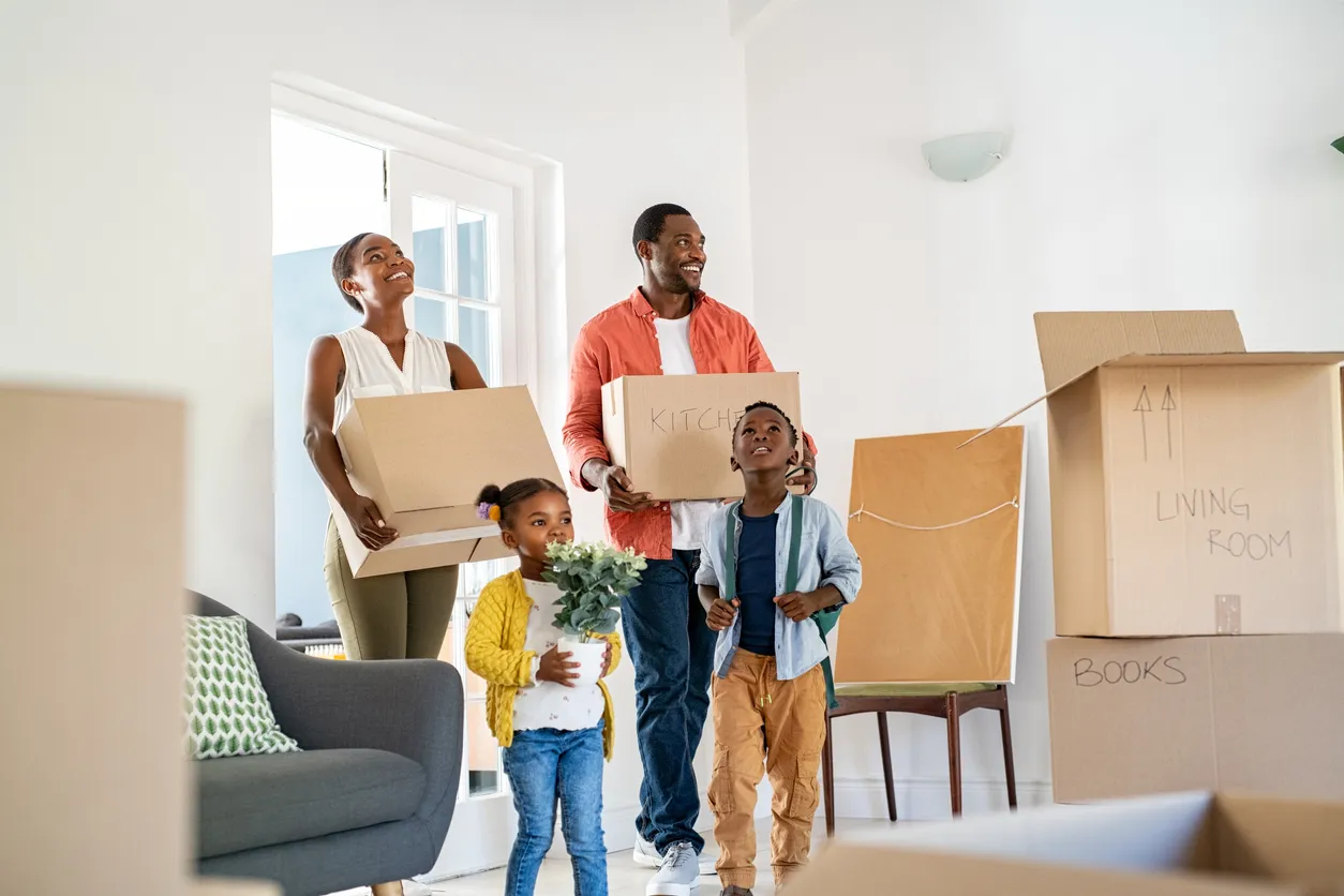 Happy family with two children moving house