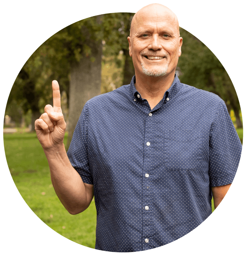 A man holding up his finger in the form of a 1