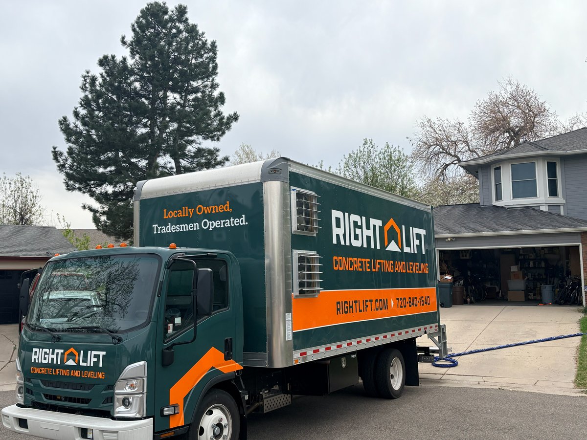 RightLift concrete lifting and leveling service truck parked in front of a house with open garage.