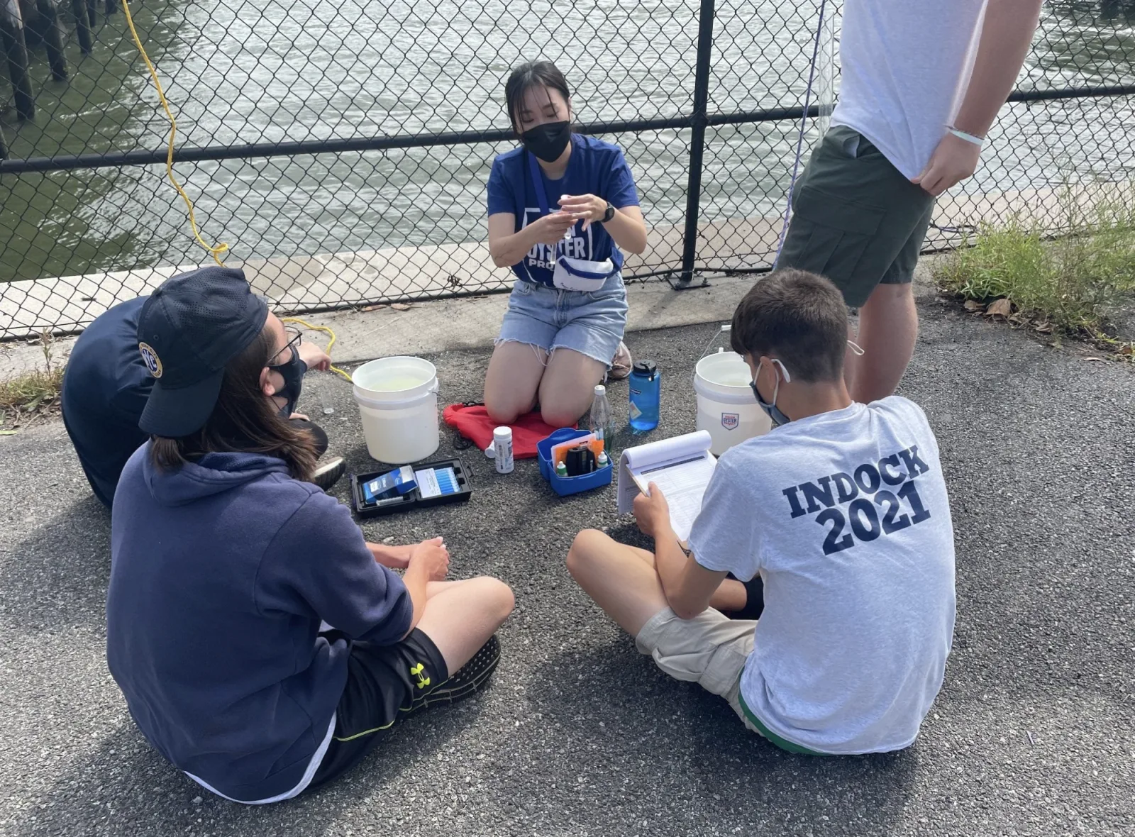 Students conduct water-quality tests together outdoors