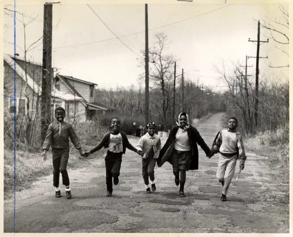 Rossville, Staten Island, 1967: five children walk hand in hand along a dirt road