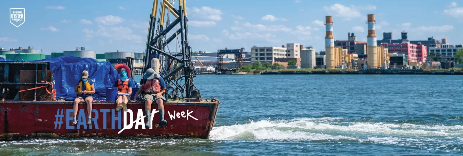 Billion Oyster Project’s Earth Day boat travels on New York Harbor with the city skyline behind it