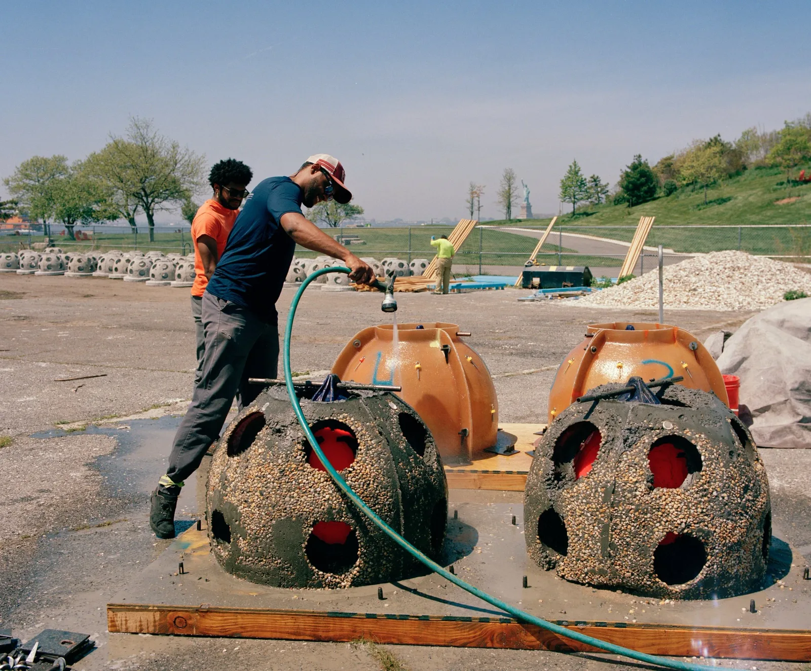 Workers prepare reef structures for deployment at an outdoor restoration site