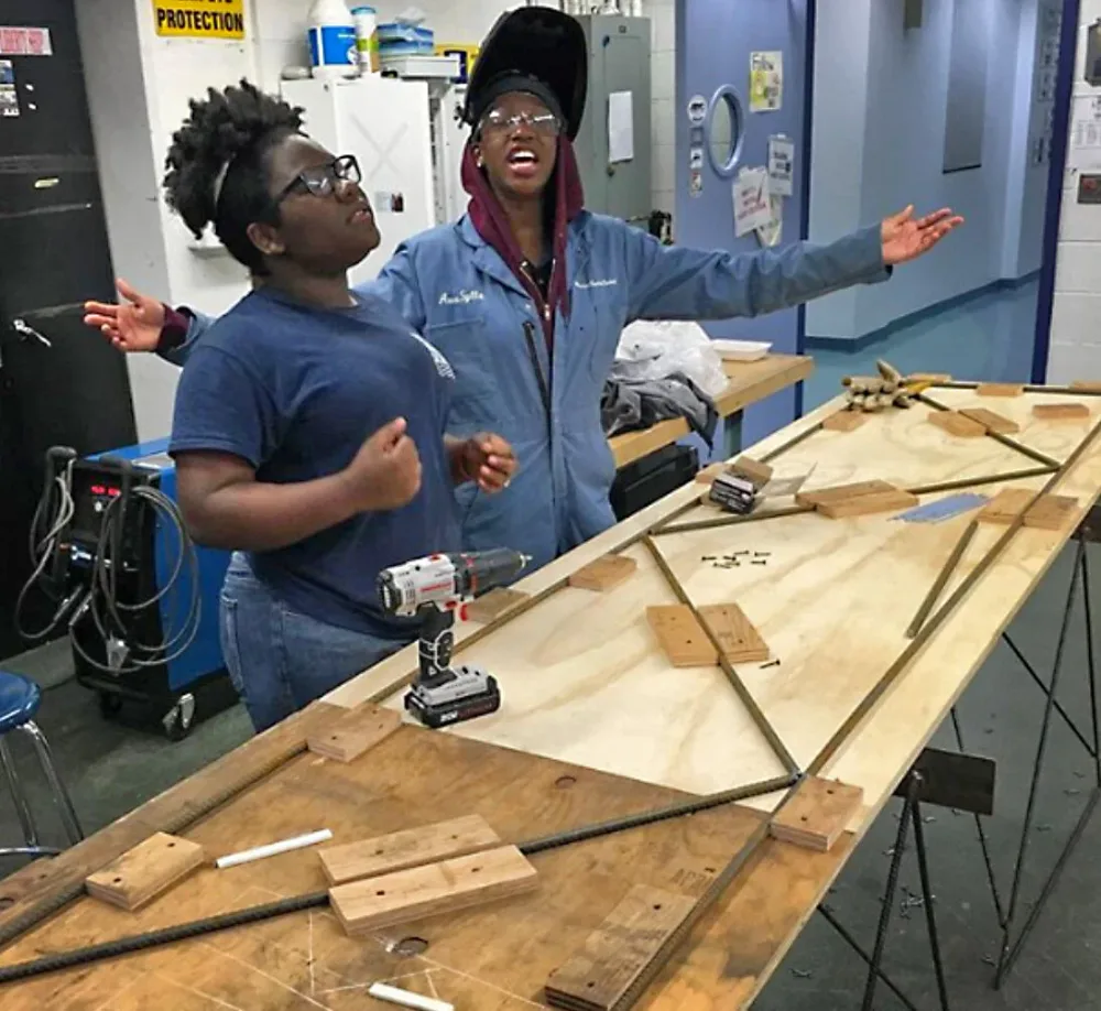 Awa Sylla works with a colleague in a fabrication shop