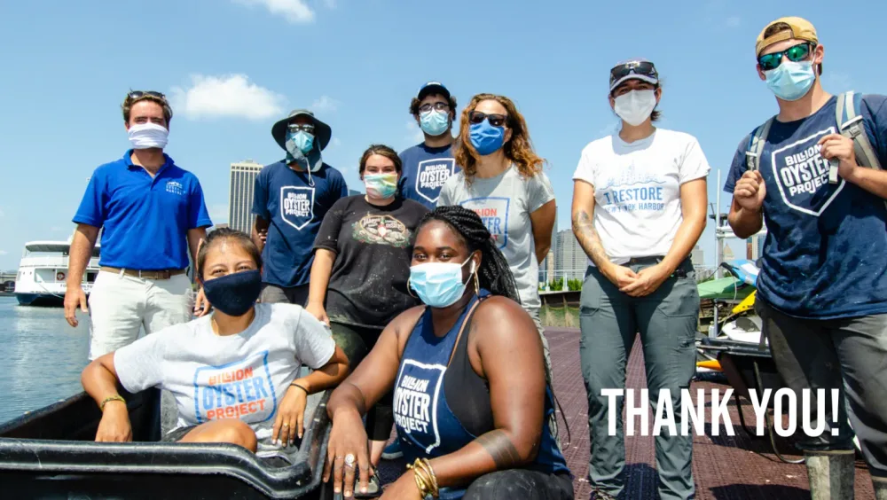 Masked volunteers pose together with a thank-you message