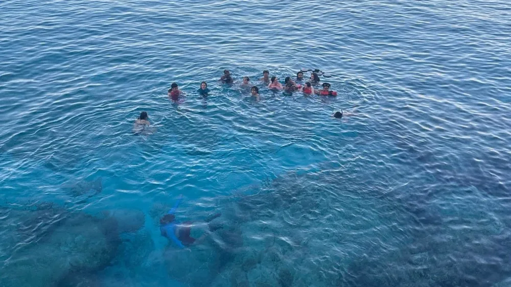 Group of divers floating together in open water