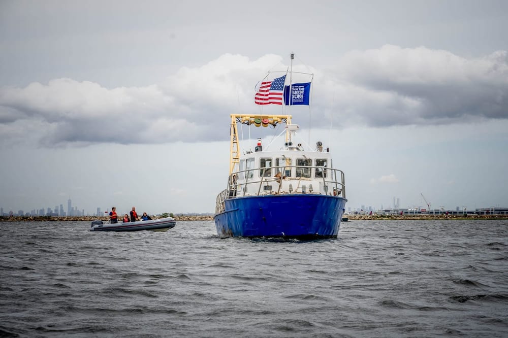 Billion Oyster Project workboat flies American and New York City flags