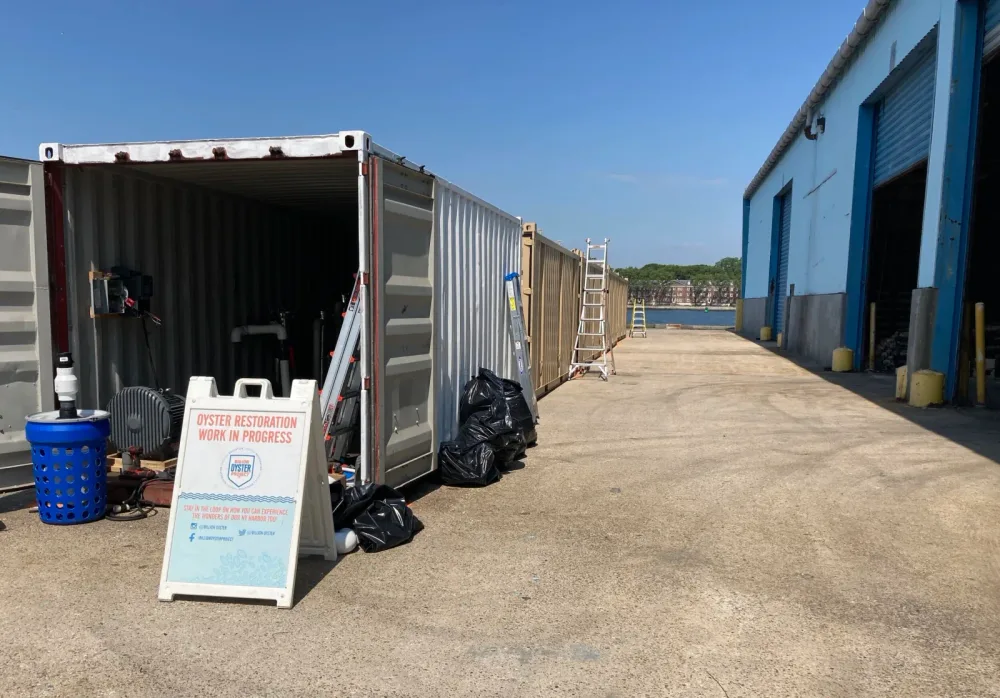 Mobile oyster restoration container and informational sign
