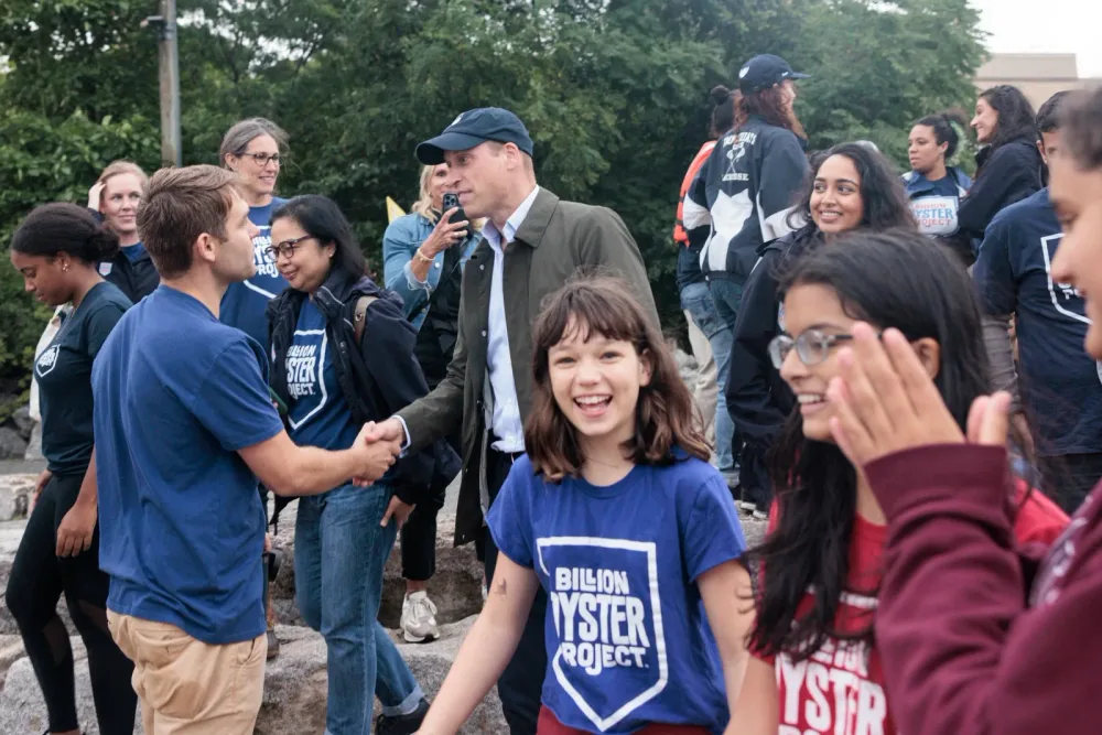 Prince William talks with students and community members at a shoreline event
