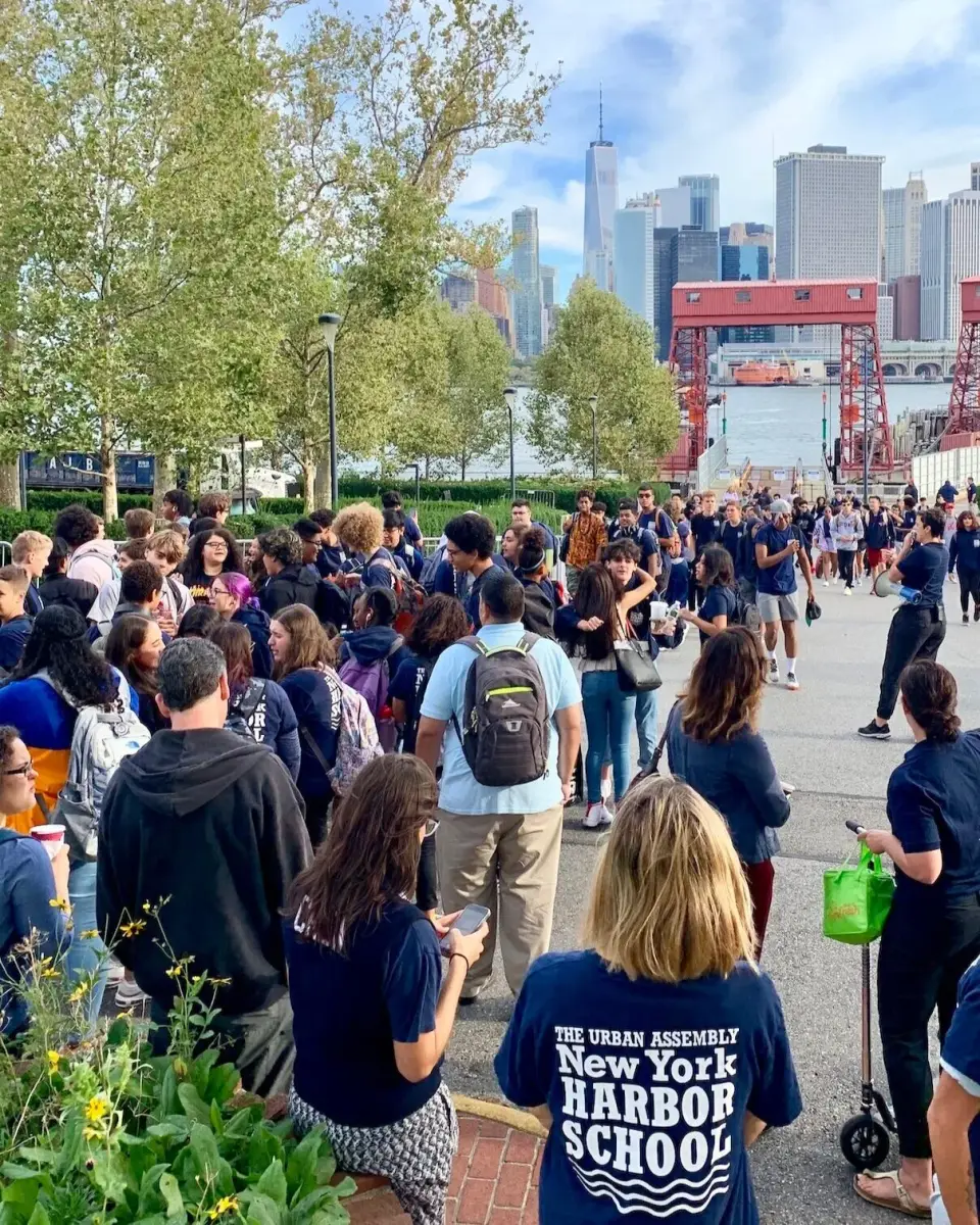 A crowd gathers for an event on the New York Harbor School waterfront