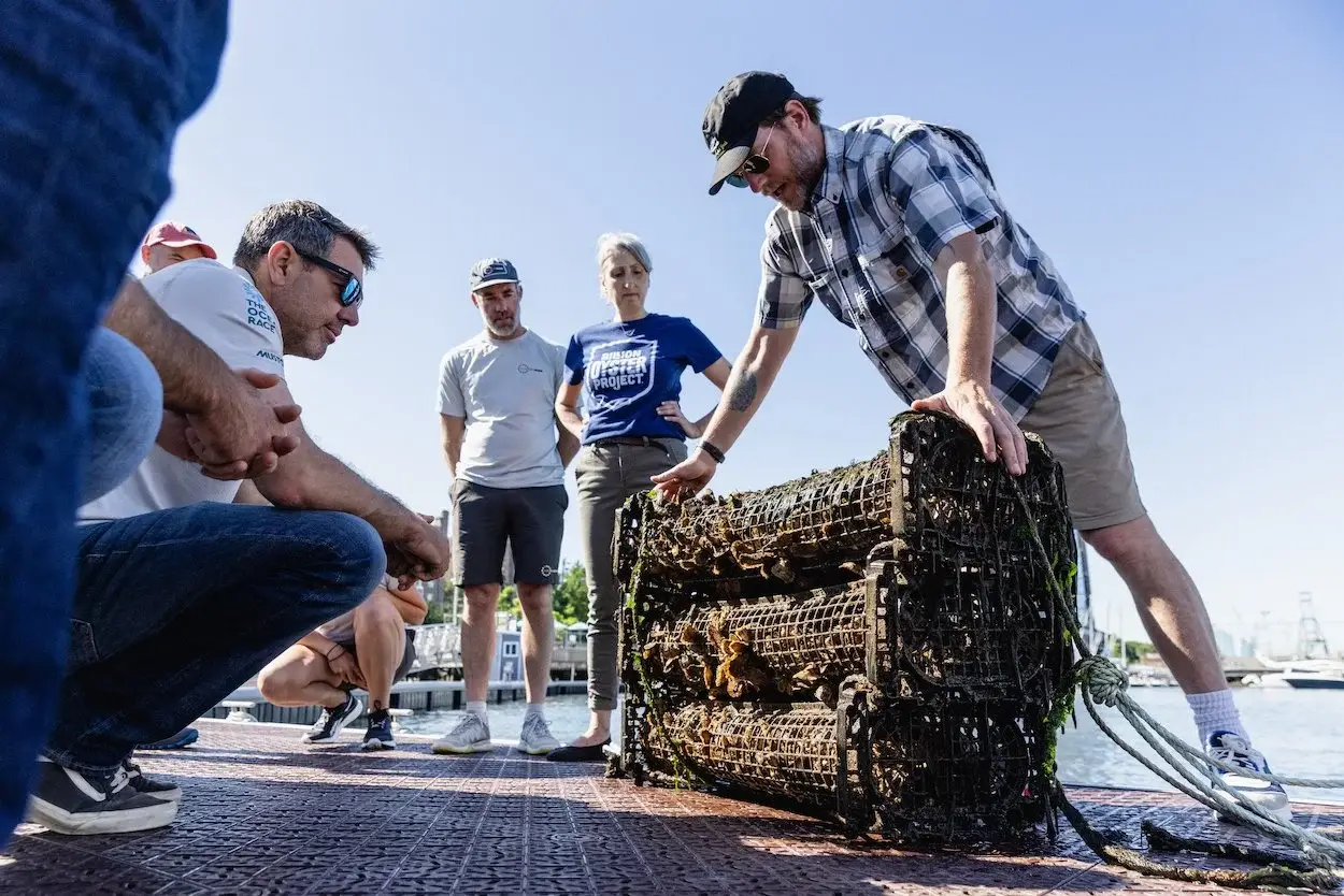 A crew examines an oyster cage aboard a boat on New York Harbor