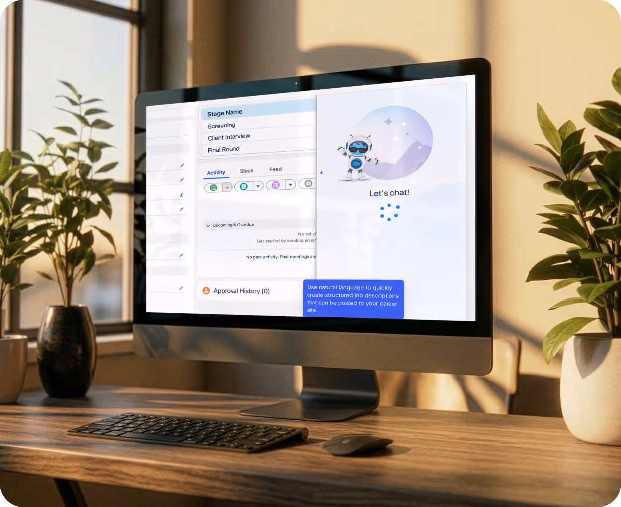 Desktop computer on wooden desk displaying a chat interface with a friendly robot and job description creation tips, flanked by two potted plants.