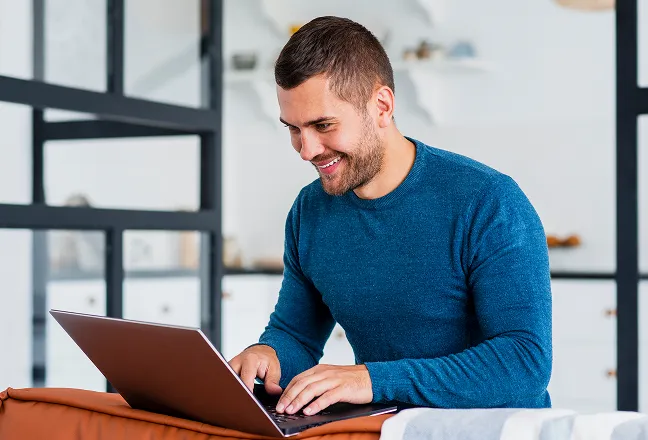 flowmile-smiley-man-working-laptop-from-home 2
