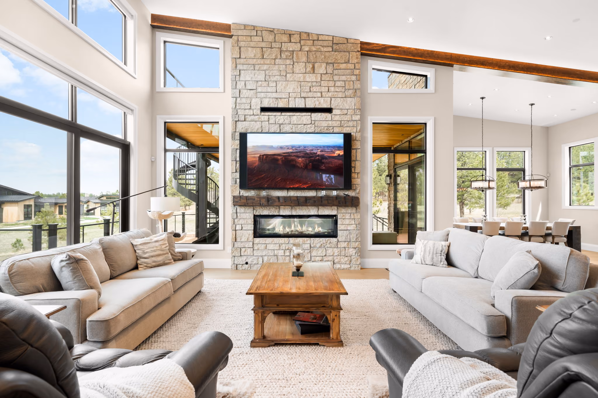 Great room stone fireplace tv centered, luxury residential smart home technology by QAV in Colorado