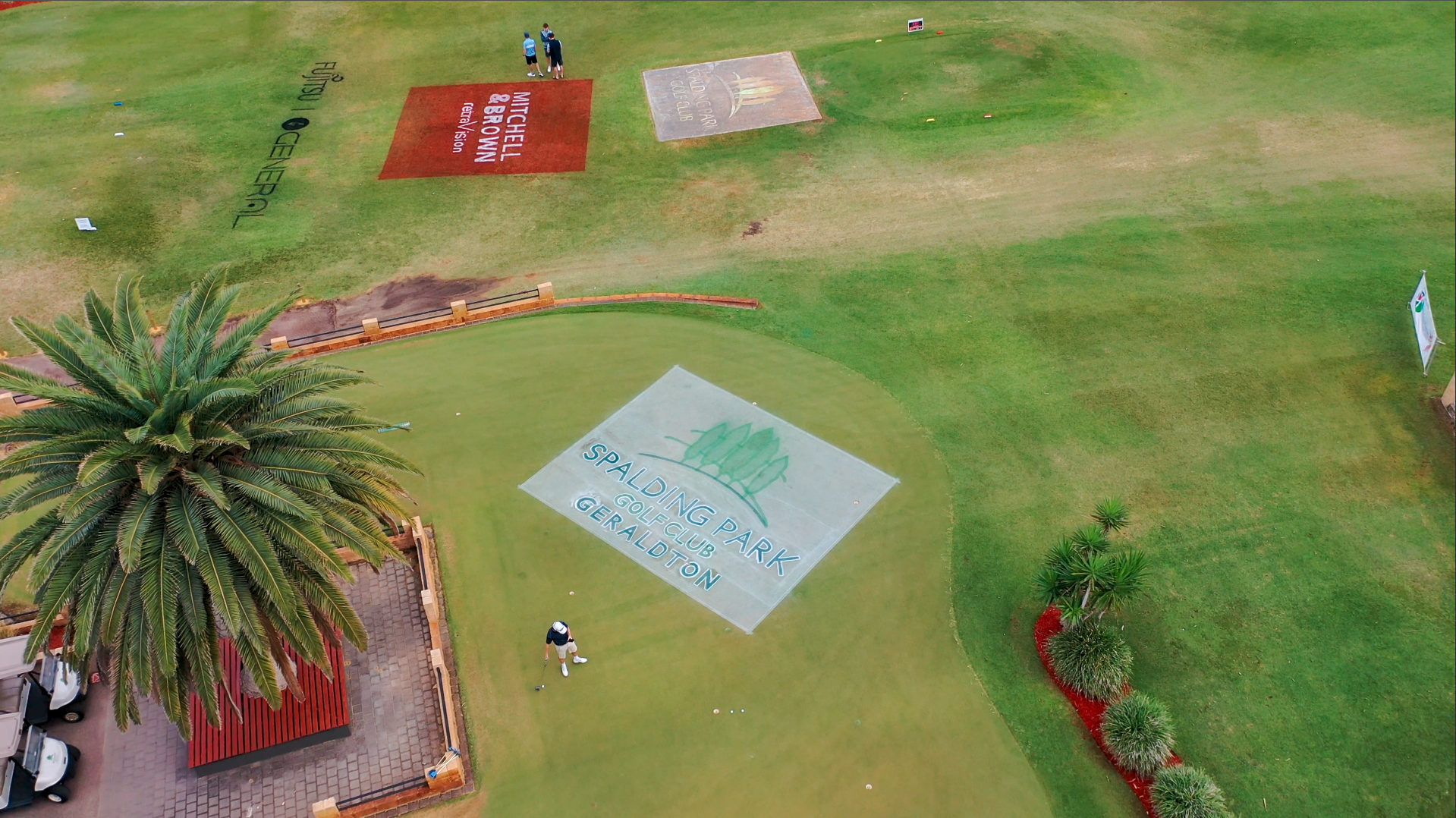 Wide aerial of Spalding Park Golf Club putting green with multiple sponsor logos