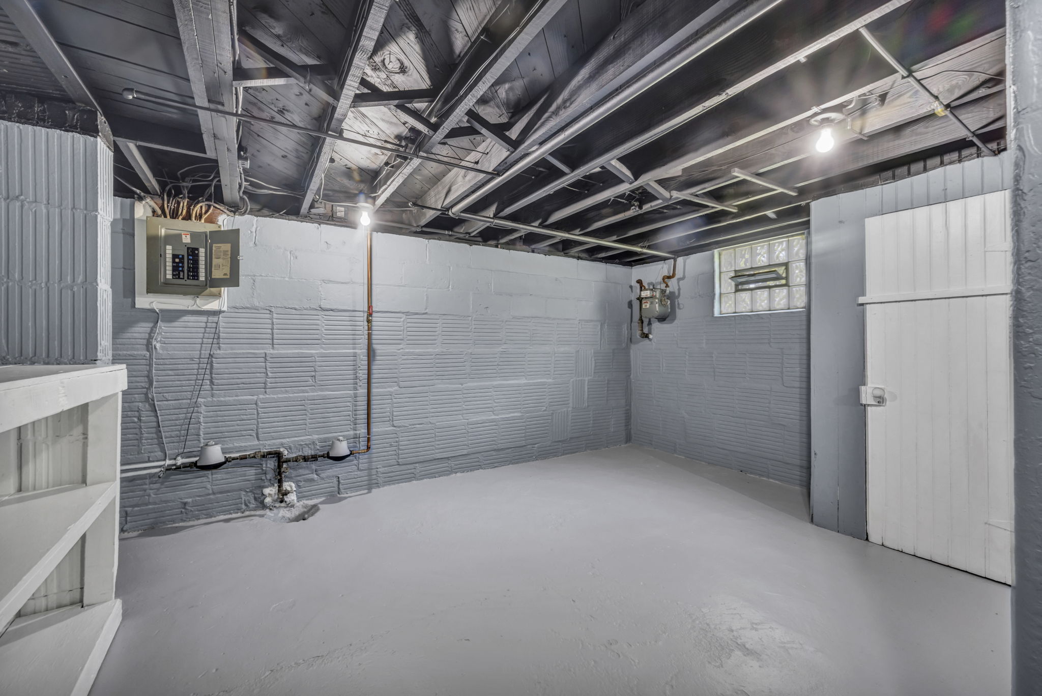 basement photo with painted floor and walls