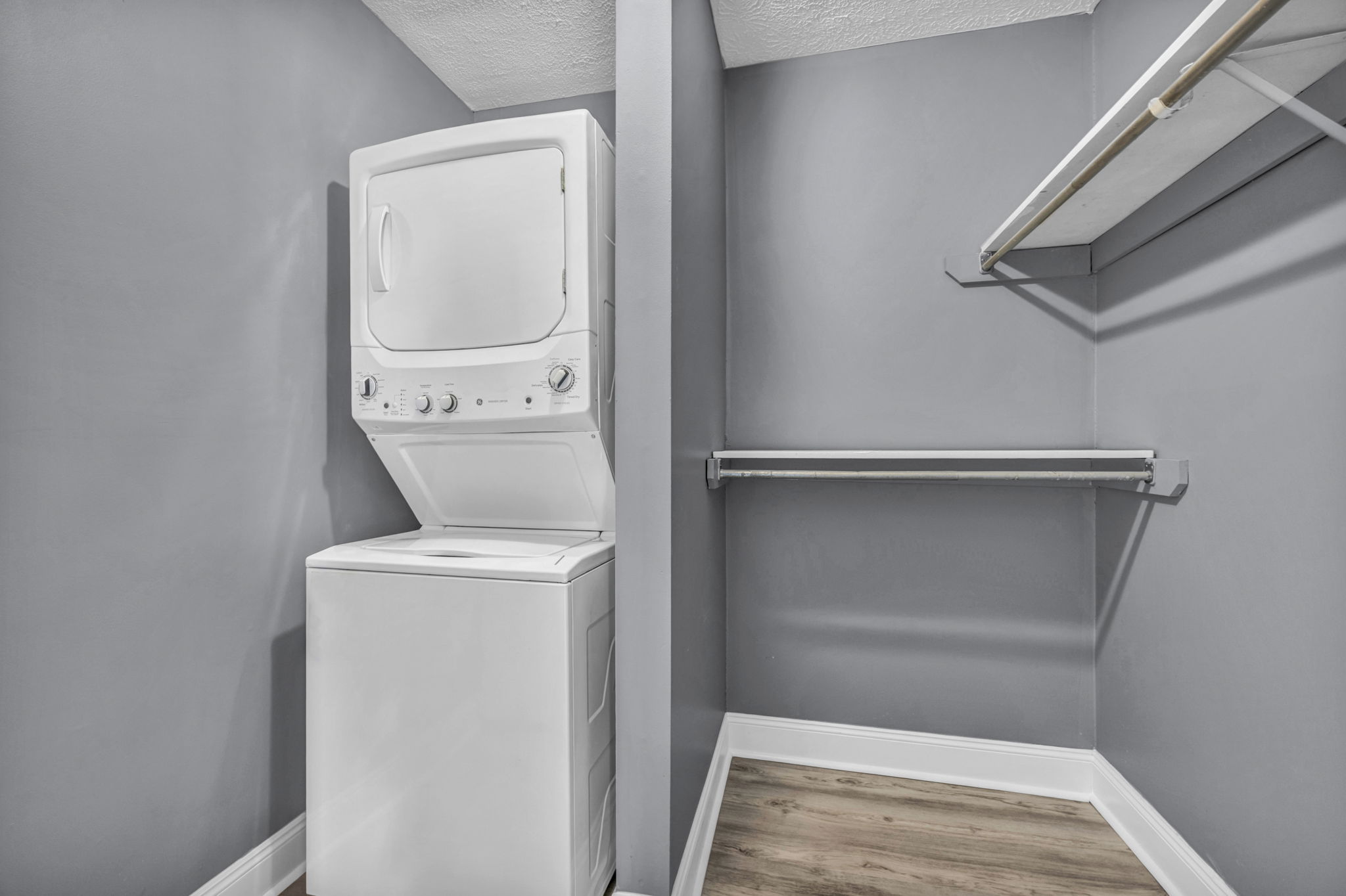 closet photo with grey walls and stacked washer dryer combo
